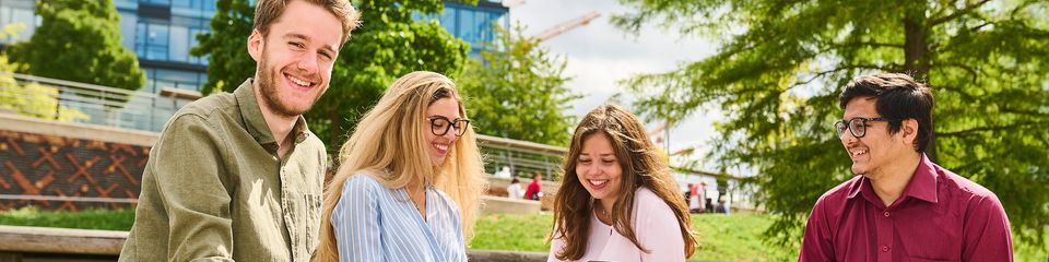 Students sitting outside in the sun.