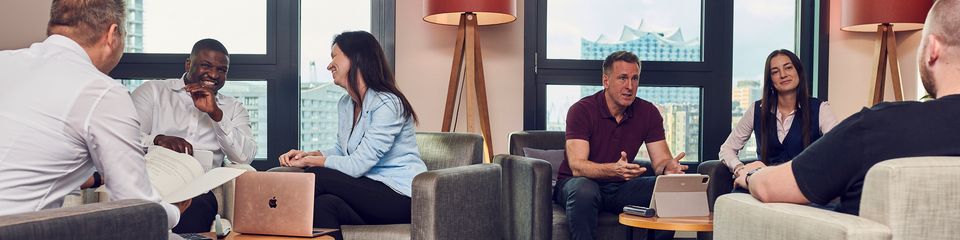 People sitting and talking in groups.